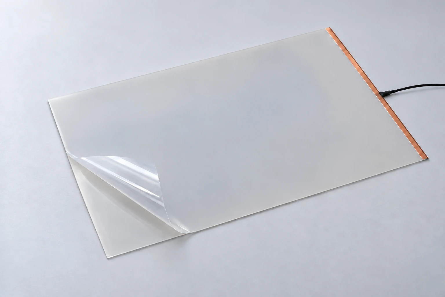 Illustration of flexible self-adhesive PDLC film with a peeled release liner and an electrical connection at the midpoint of the right copper edge